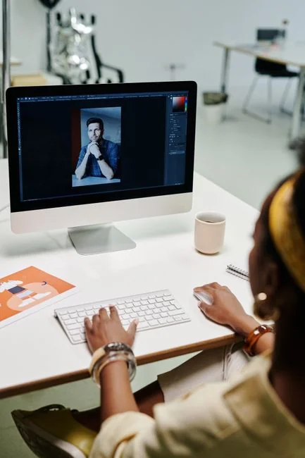 A stylish workspace featuring a laptop and monitors displaying design software.